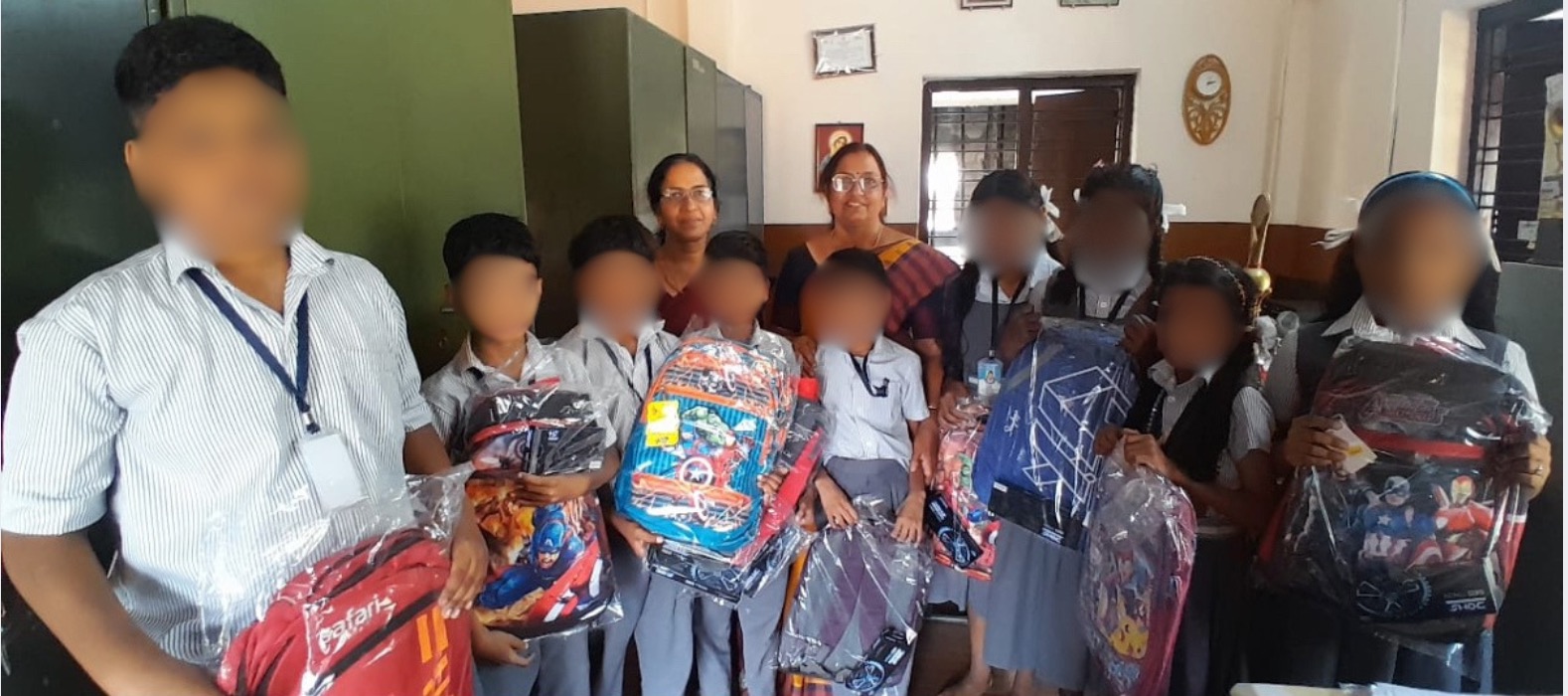 Children receiving backpacks and school supplies